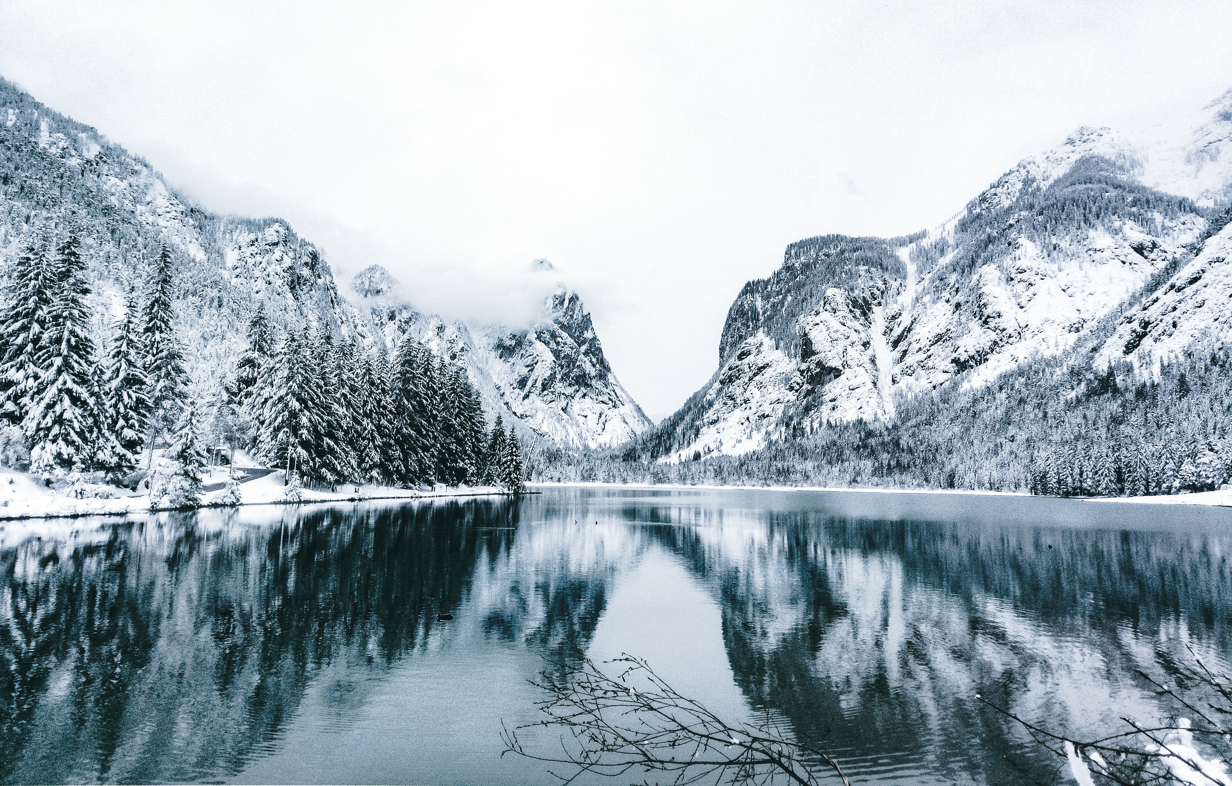 grayscale photo of lake near mountain